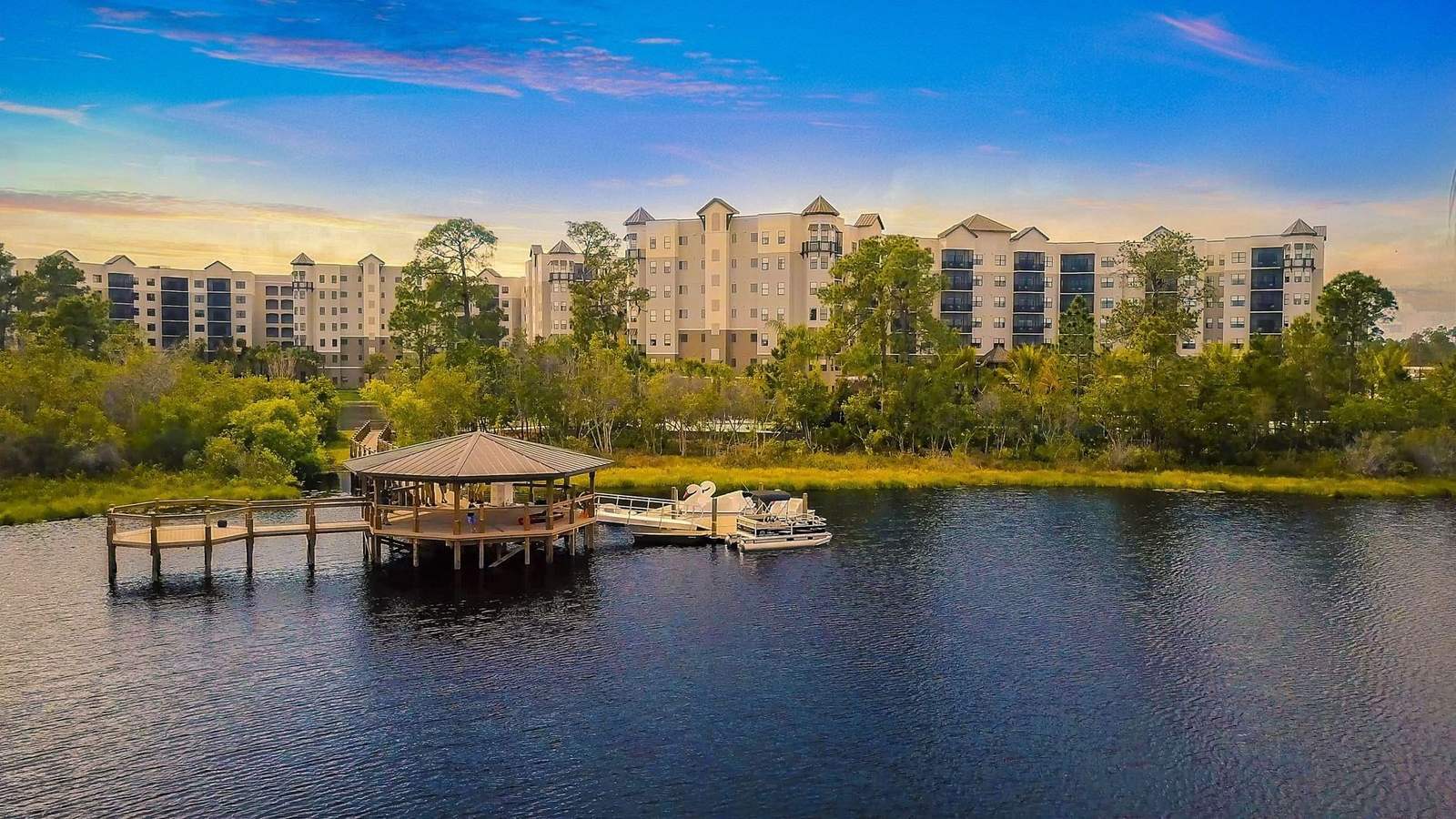 The Grove Resort's condominium buildings seen from the Lake Austin pier at dusk